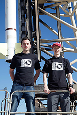 UMASS Lowell Research Scientist Christopher Mendillo (L) and Ewan Douglas, a BU Astronomy graduate student (R) stand at the base of a rocket mounted on a launcher. PHOTO COURTESY US ARMY WHITE SANDS MISSILE RANGE