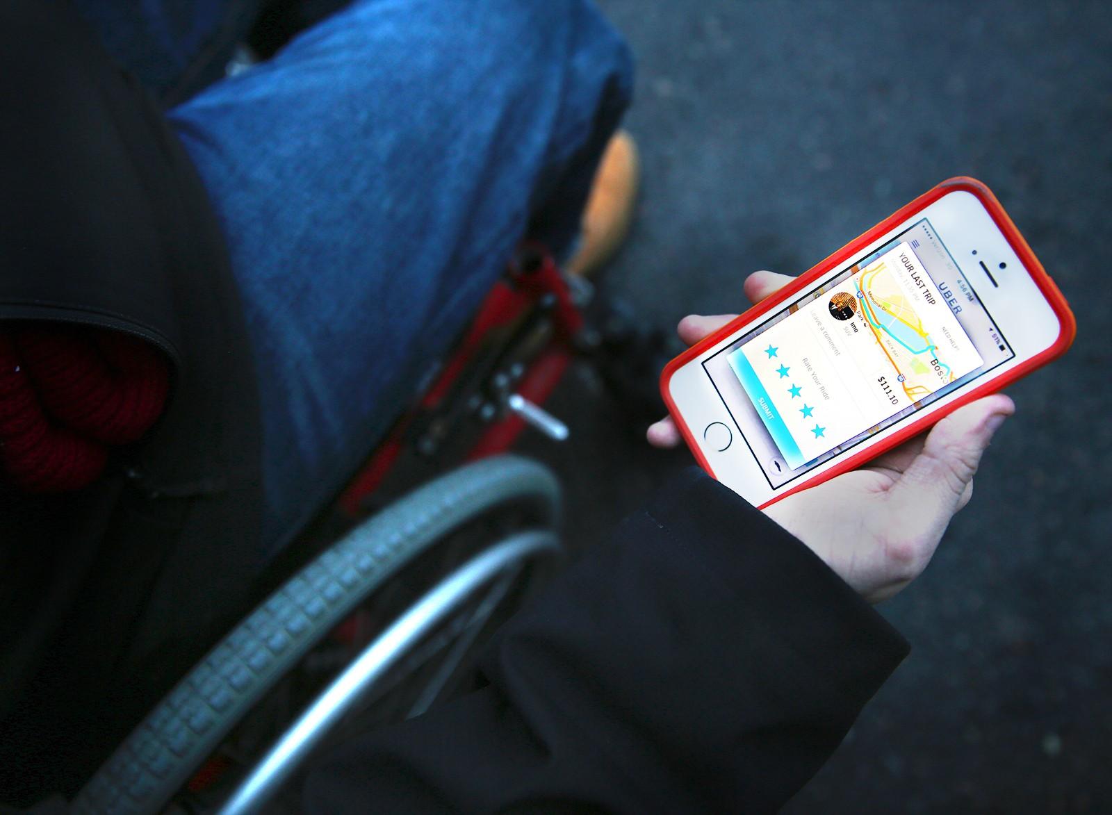 Massachusetts Gov. Charlie Baker is partnering with ride-hailing services Lyft and Uber to make MBTA Paratransit more accessible for people who need it. PHOTO BY SARAH SILBIGER/ DFP FILE PHOTO