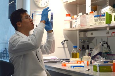 boston university student researcher handles equipment in a laboratory