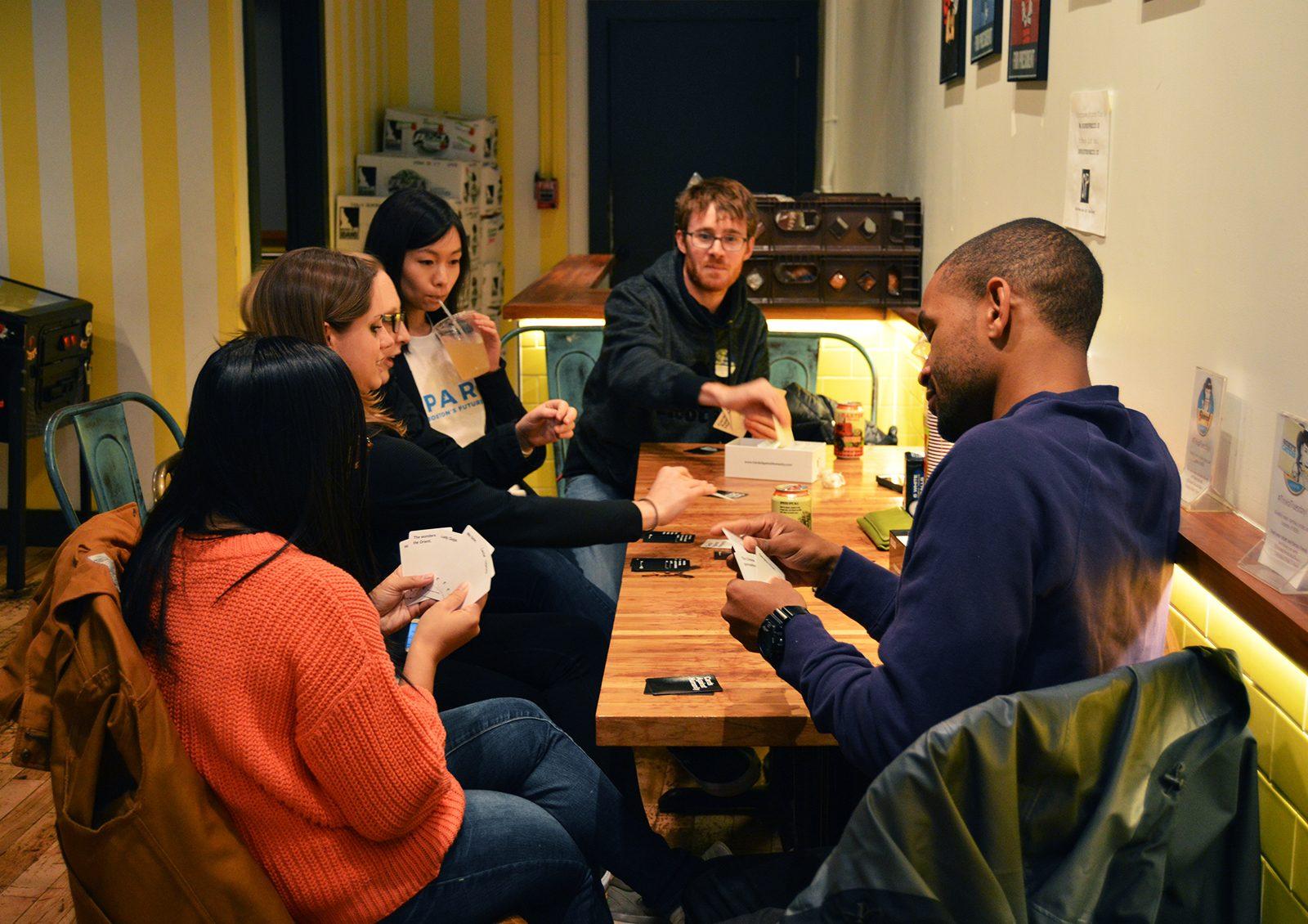 Before heading to the polls, voters play a game of Cards Against Humanity at Roxy’s Grilled Cheese in Allston. PHOTO BY ERIN BILLINGS/ DAILY FREE PRESS STAFF
