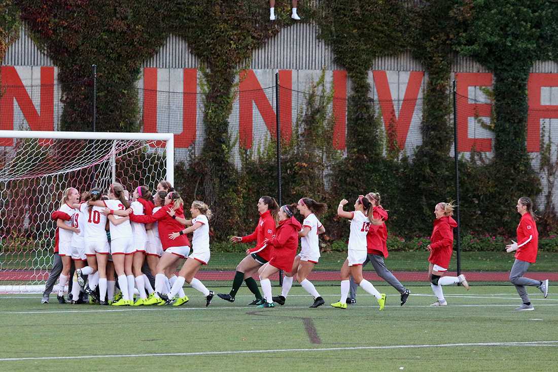 The Boston University women’s soccer team rushes Nickerson Field after a win in November 2018. MADISON EPPERSON/ DFP FILE