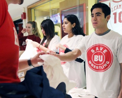 Students hand out “Save BU Wrestling” shirts at the program’s final meets before being disbanded by the athletics department last year. PHOTO BY MICHELLE JAY/DFP FILE PHOTO