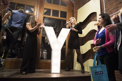 Y Society founders Sarah Gaines and Abbey Titcomb address the crowd at The Y Society party held at Janji pop up shop on Newbury Street Thursday night.
