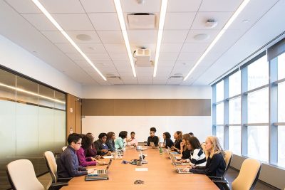employees around a table in a conference room