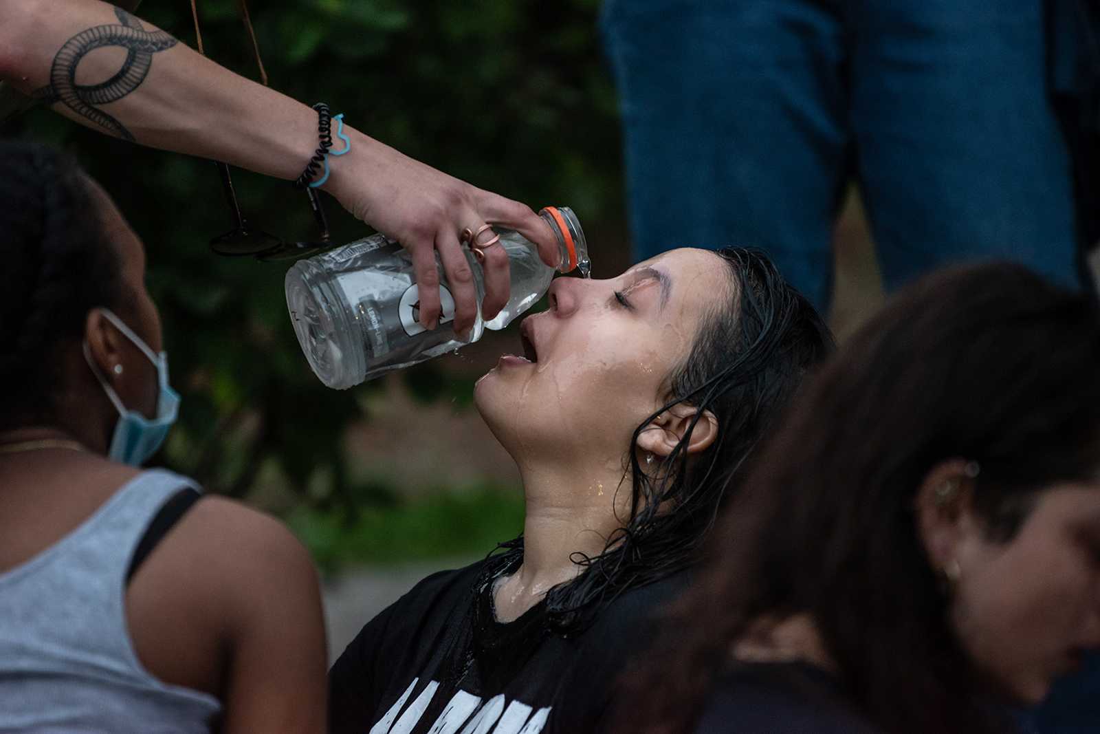 Protester Rania Belqaie gets her eyes washed with water after being pepper-sprayed by a Boston police officer during a march against police brutality in May. On Thursday, Massachusetts state representatives voted against an amendment that would have banned the use of tear gas and other chemical agents by police in the state. LAURYN ALLEN/ DAILY FREE PRESS STAFF
