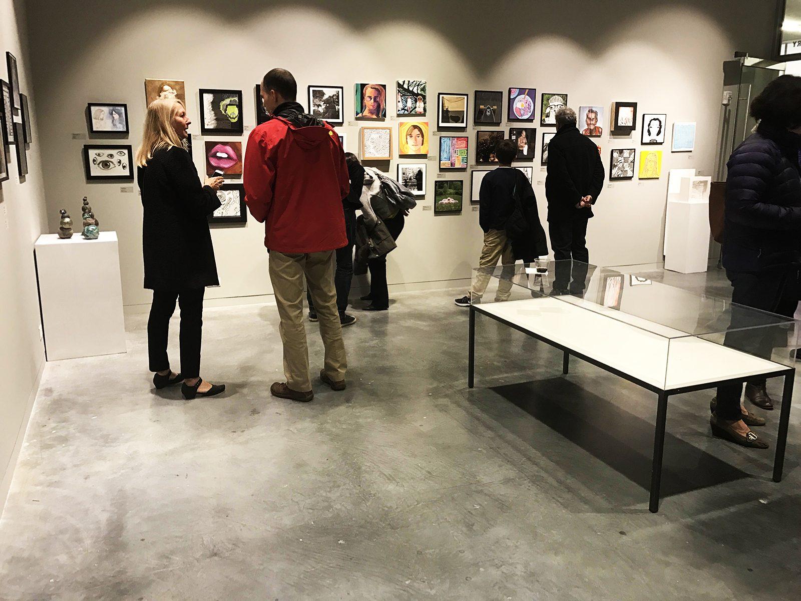 Patrons view an art exhibition featuring the work of students from New England preparatory schools Friday in the Lunder Art Center at the Lesley University College of Art and Design. PHOTO BY ROSHNI KOTWANI/ DAILY FREE PRESS STAFF