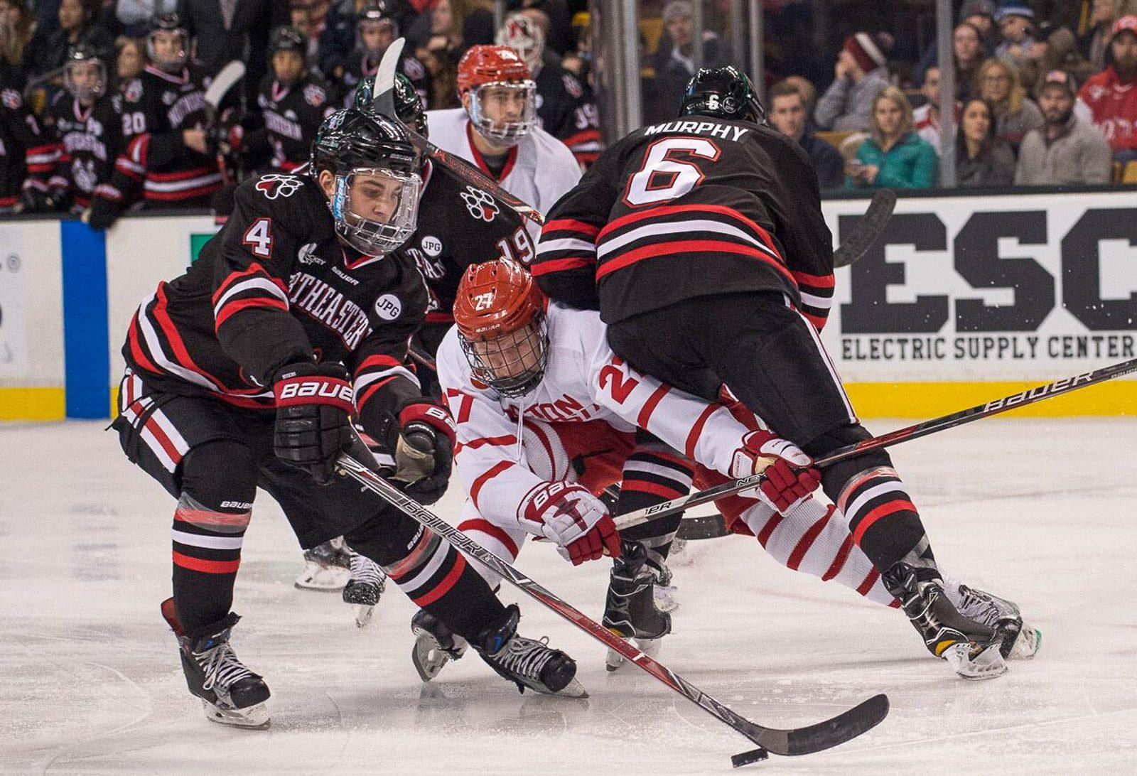 Northeastern University defensemen Jeremy Davies (left) and Collin Murphy (right) and former Boston University forward Brady Tkachuk (center) during the Beanpot final in February. MADDIE MALHOTRA/ DAILY FREE PRESS STAFF
