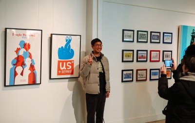 A man poses with Bernie Sanders-inspired art at “The Art of a Political Revolution,” a gallery show at the Artists For Humanity EpiCenter on exhibition Friday through Sunday. PHOTO COURTESY TYLER GIBNEY