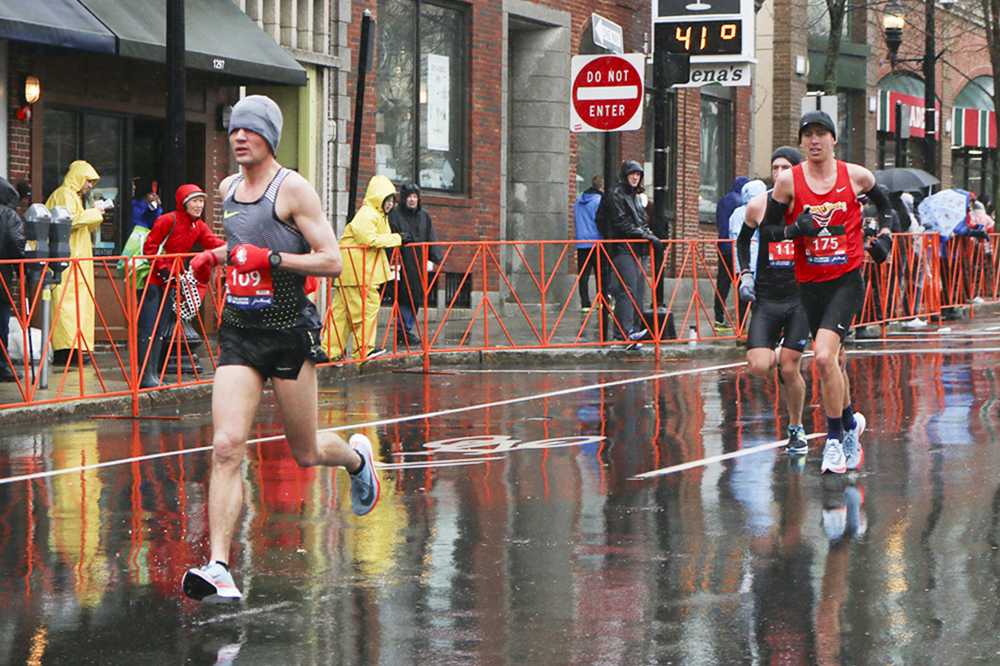 Jackson Neff of Chicago runs ahead of William Graham and Matt Marol in the Boston Marathon on Monday. PHOTO BY BETSEY GOLDWASSER/DAILY FREE PRESS STAFF

