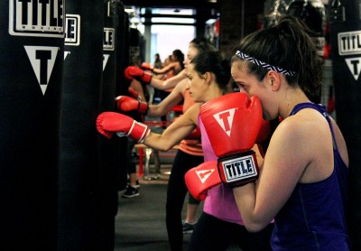 Attendees box during the first class at TITLE Boxing Club, which was opened Tuesday by Boston University alumna Jessica Musto. PHOTO BY SARAH SILBIGER/DAILY FREE PRESS STAFF