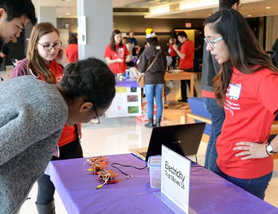 Allie Silverman (CAS '16) and Camila De Freitas (CAS '17) host a table on electricity at Bringing Recognition and Interest to Neuroscience (BRAIN) Day in the George Sherman Union Sunday. PHOTO BY DANIEL GUAN/DAILY FREE PRESS STAFF