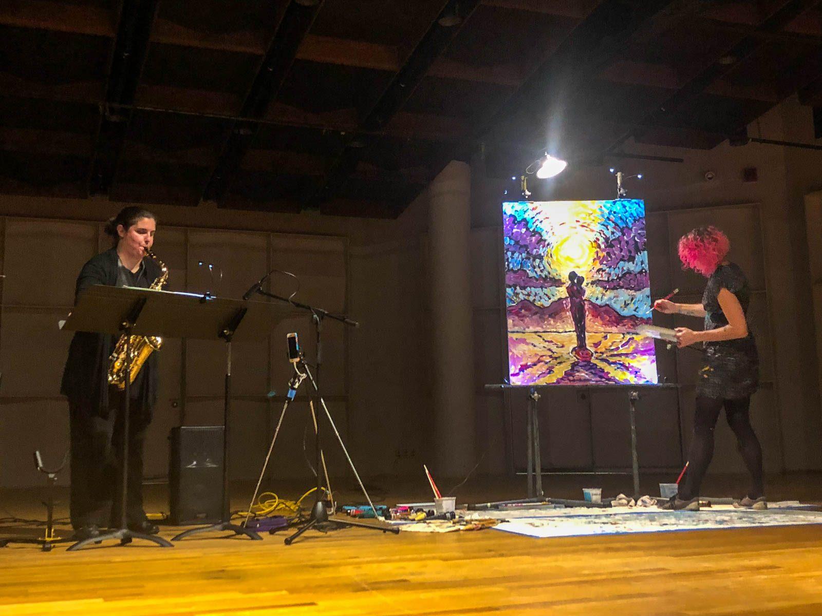Jennifer Bill, a saxophone professor in the College of Fine Arts, and Visual artist Linnea Maas collaborate together for a live performance at BRUSH|REED last Tuesday. PHOTO BY JULIA MARUCA/ DAILY FREE PRESS STAFF