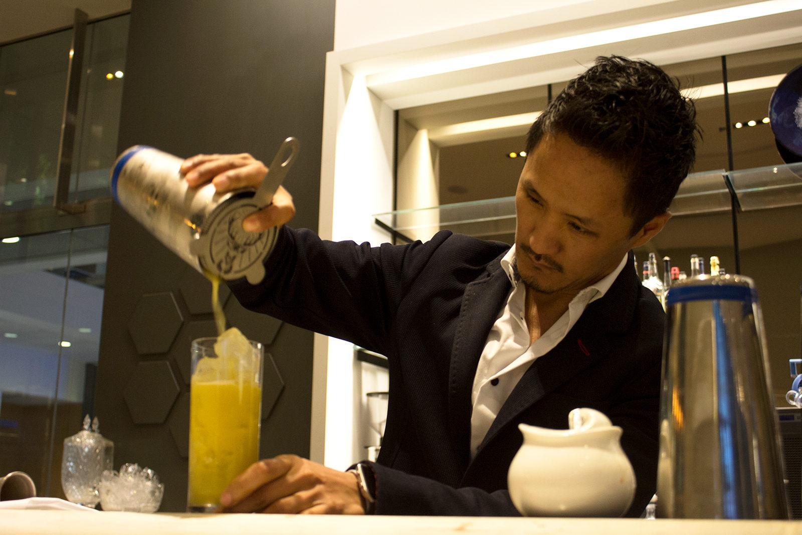 Café ArtScience bar director Tenzin Samdo mixes a drink during his shift Thursday afternoon. A Boston University professor at the Questrom School of Business is facing criticism for acting hostile towards Samdo and other employees at the restaurant. PHOTO BY JENNA MANTO/ DAILY FREE PRESS STAFF