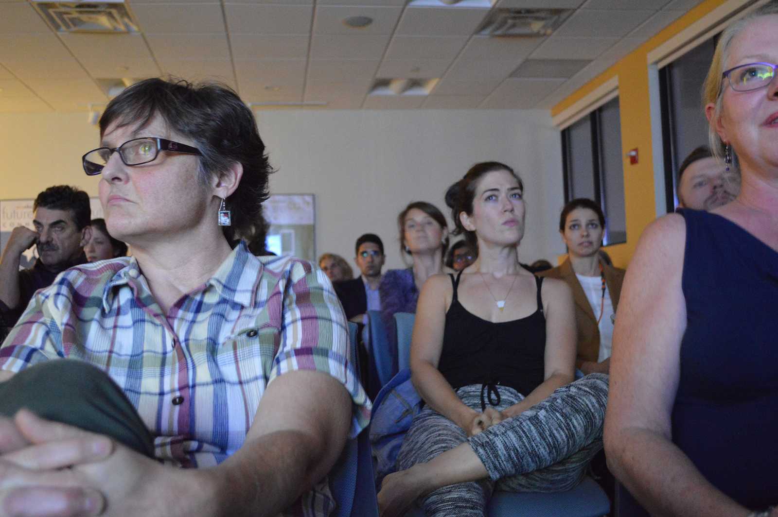 During a viewing held at WBUR, the crowd listens intently to Republican presidential nominee Donald Trump’s remarks during the debate. The event was hosted by WBUR’s senior political reporter Anthony Brooks and political journalist Ken Rudin. PHOTO BY CAROLYN KOMATSOULIS/ DAILY FREE PRESS STAFF