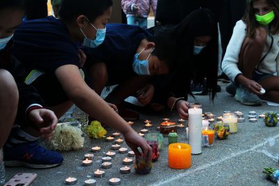 children light candles at a stop asian hate protest