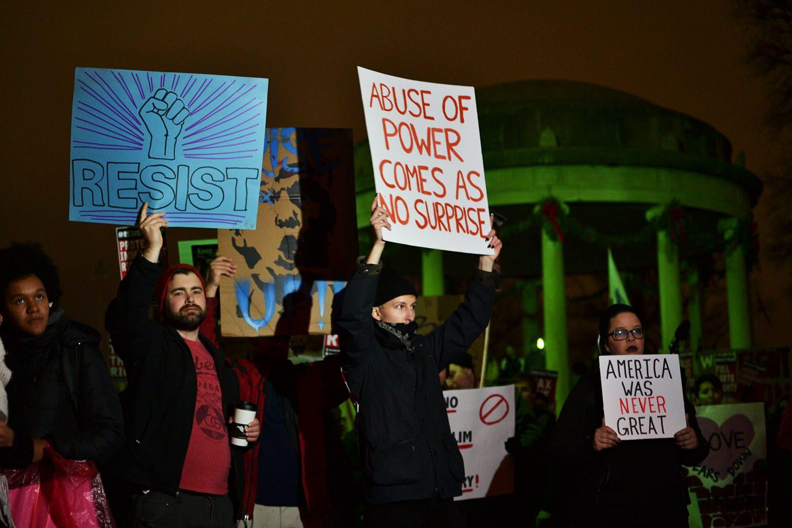 A woman holds a sign that states “Abuse of power comes as no surprise.” PHOTO BY CHLOE GRINBERG/ DAILY FREE PRESS STAFF