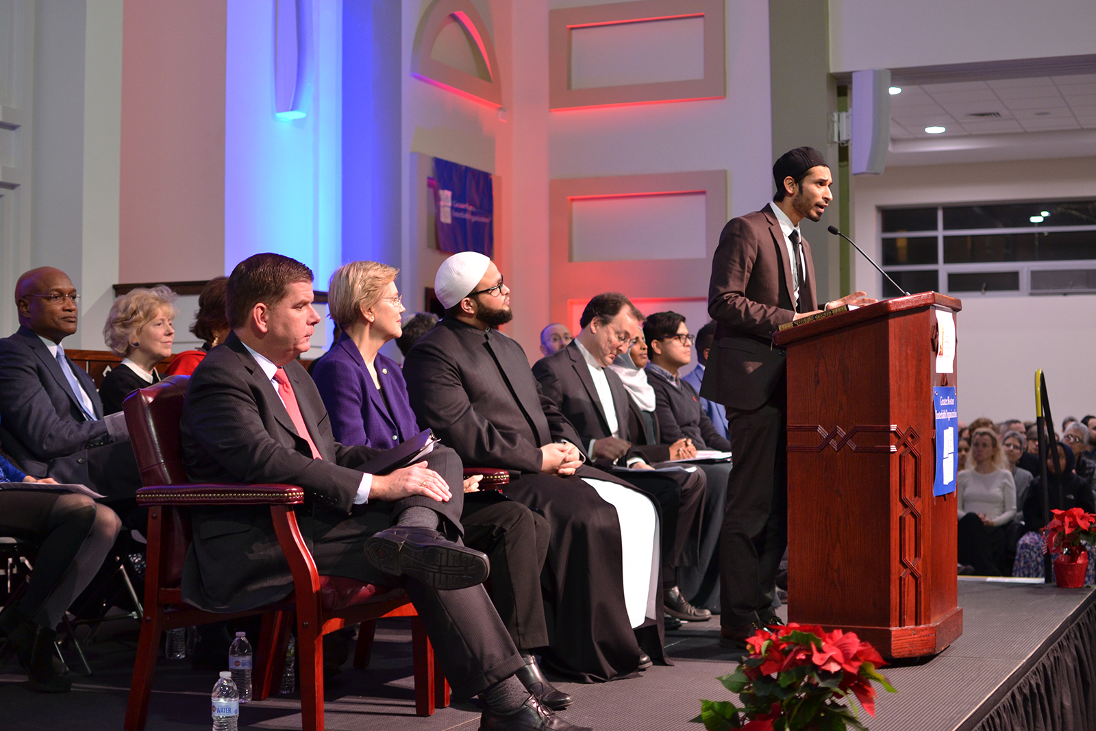 Boston Mayor Martin Walsh and Massachusetts Sen. Elizabeth Warren listen to Yusufi Vali address the crowd Sunday evening at the Islamic Society of Boston Cultural Center. PHOTO BY CHLOE GRINBERG / DAILY FREE PRESS STAFF