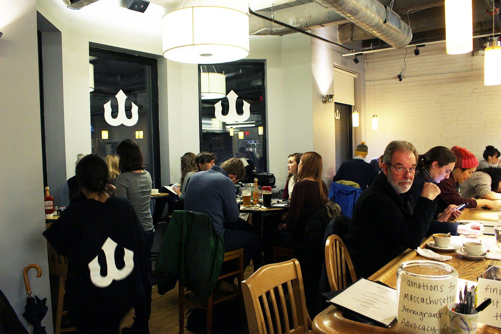 Bostonians gather at Trident Booksellers and Cafe to write to local representatives on Feb. 7. PHOTO BY COLE SCHONEMAN/ DAILY FREE PRESS STAFF