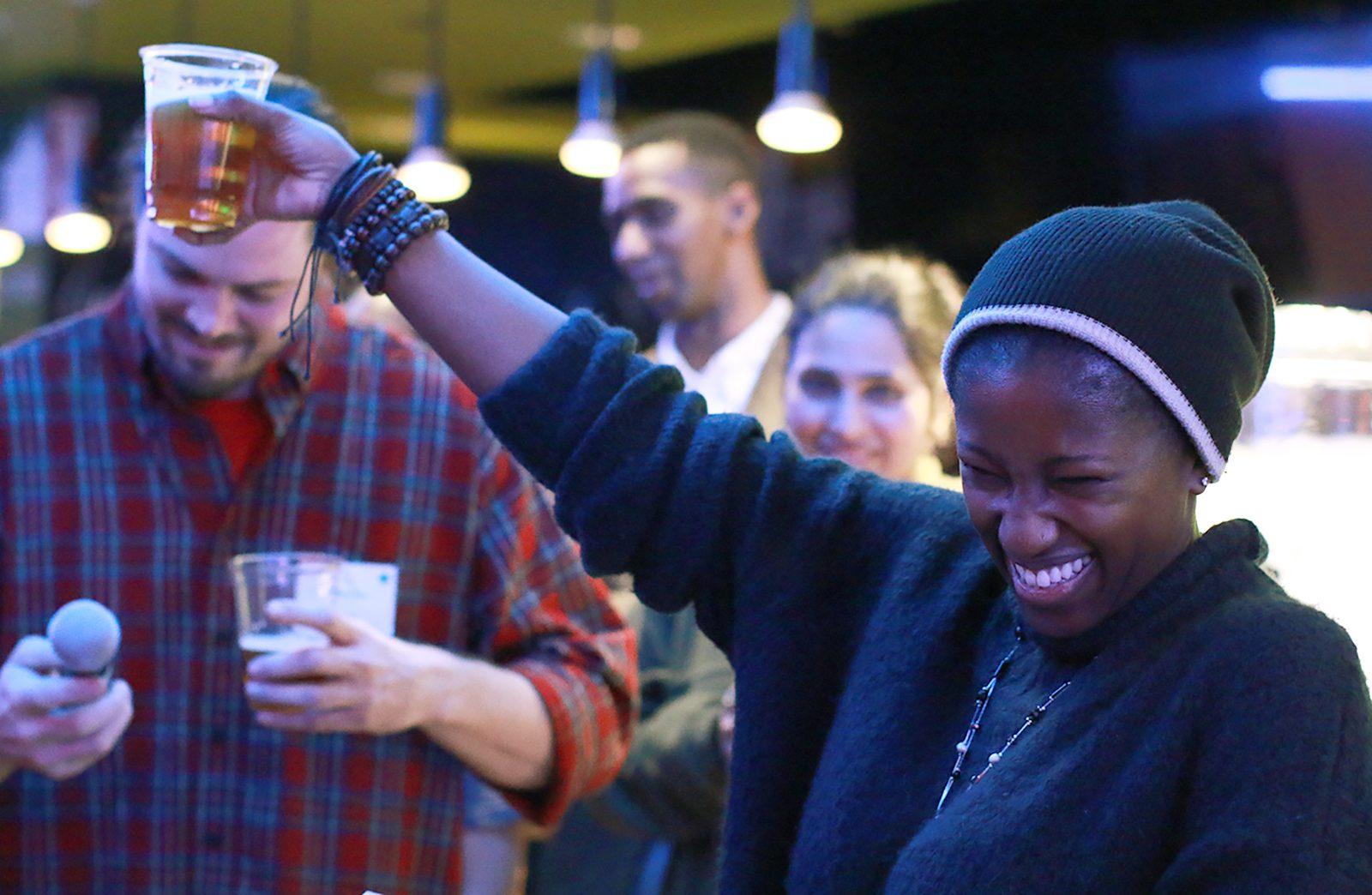CODE RED founding member Adaora Asala raises her cup during a speech at the CODE RED official launch party on Thursday at District Hall in Boston. PHOTO BY JACQUELYN O’BRIEN/ DAILY FREE PRESS STAFF 