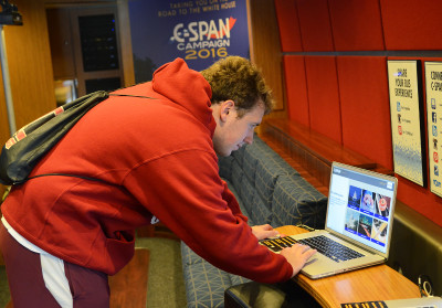 Tyler Durniak, CAS '17, uses a computer loaded with public affairs programming and educational resources inside the visiting C-SPAN bus on Boston University's Charles River Campus Tuesday. PHOTO BY DANIEL GUAN/DAILY FREE PRESS STAFF