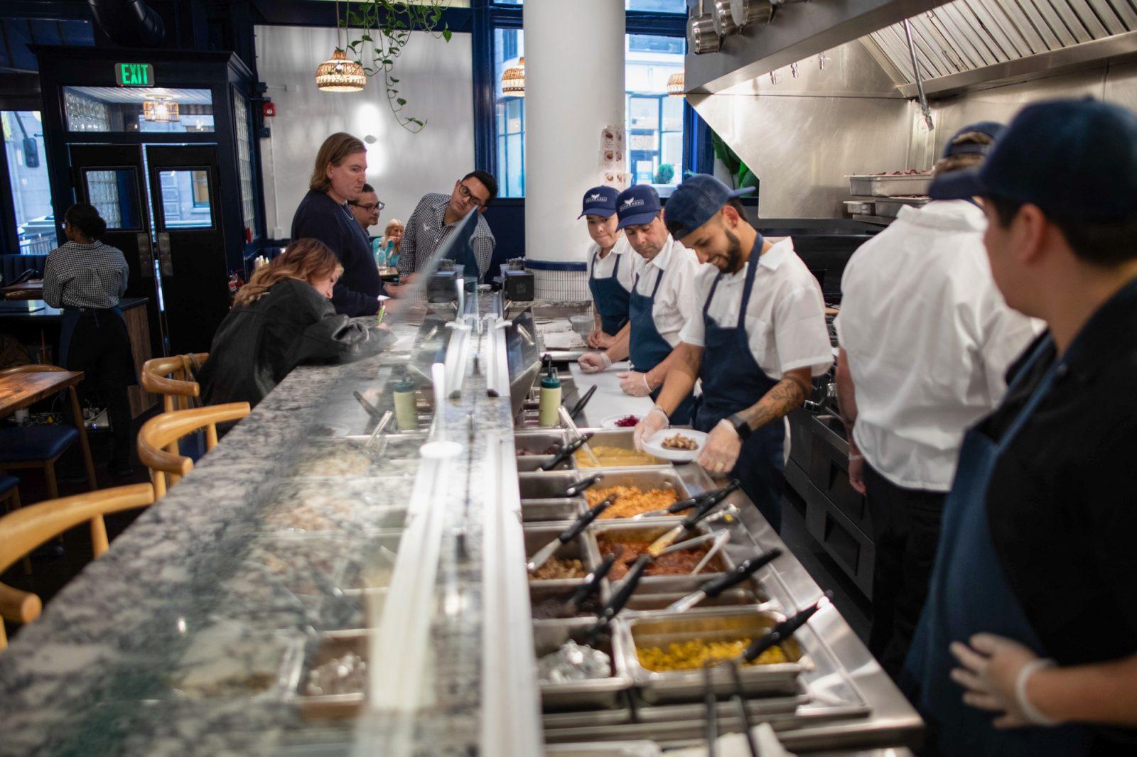 Taco Azul workers make tacos on Oct. 17, the restaurant’s first day open to the public. Taco Azul is a new Mexican restaurant in Beacon Hill with a menu focused on guacamole, tacos and margaritas. BARRETT WALSH/DFP PHOTOGRAPHER