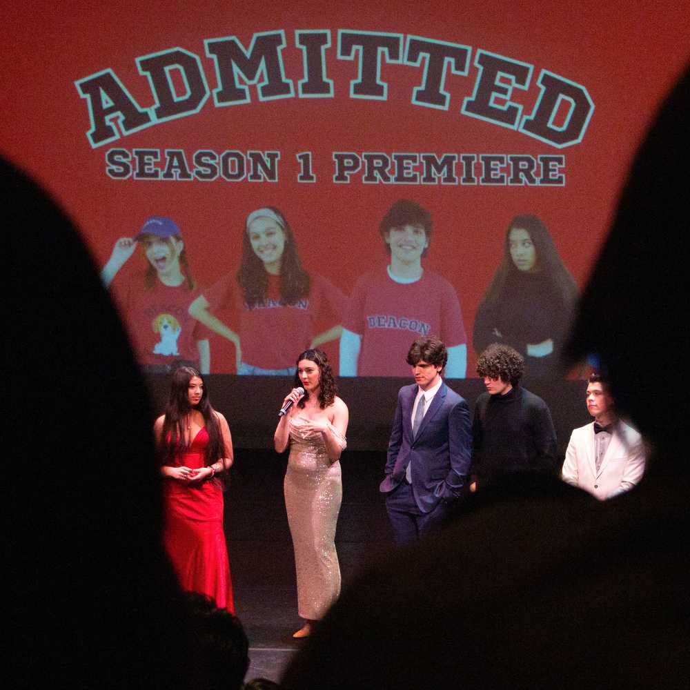 “Admitted” writer and actor Maggie Borgen talks before the premiere event surrounded by other cast.