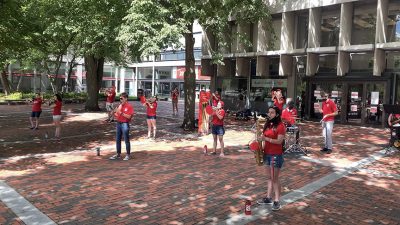 boston university pep band performs in front of the george sherman union