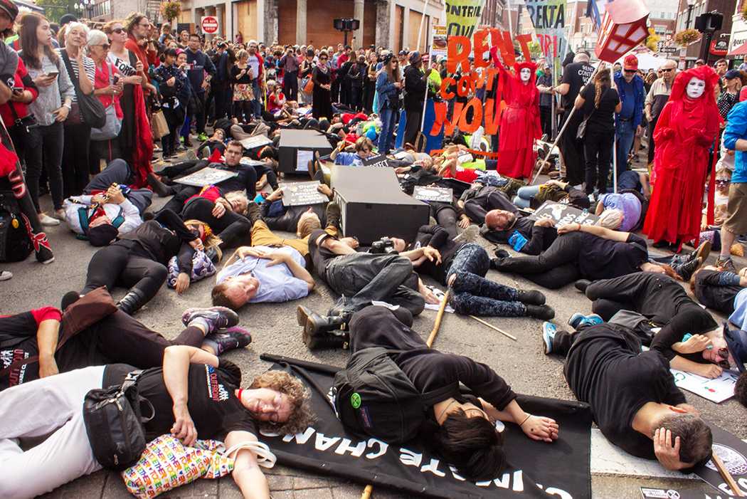 Extinction Rebellion protestors lie on the ground during the Honk! Festival, which brought together various social organizations for a march from Somerville to Cambridge on Sunday. ANJU MIURA/ DAILY FREE PRESS STAFF