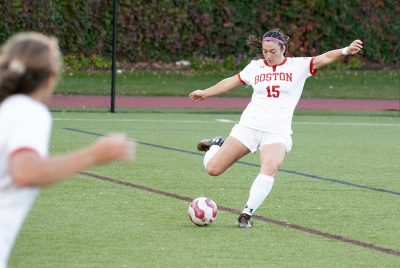 margaret berry prepares to kick a soccer ball against harvard university