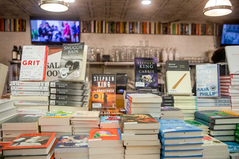 Books stacked in front of a coffee bar at Trident Booksellers on Newbury Street. MADI KOESLER/DFP PHOTOGRAPHER