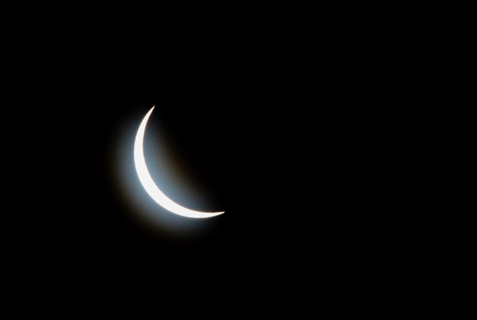 The solar eclipse as it reached a 93% partial eclipse in Boston. CLARE ONG/DFP PHOTOGRAPHER