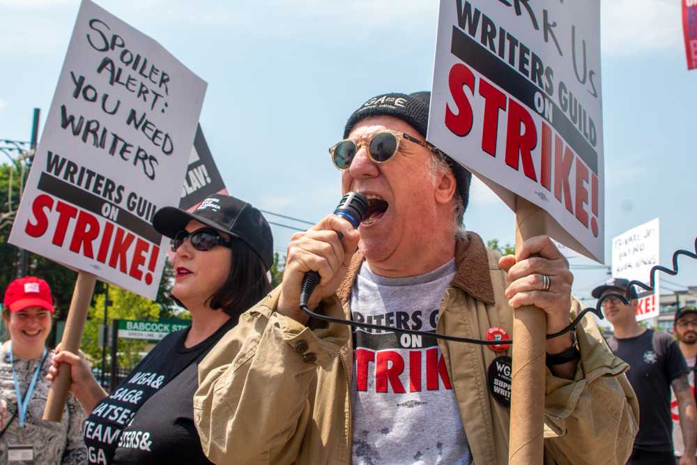 Writers Guild of America members picket near Babcock Street station in response to David Zaslav’s 2023 commencement speech. Writers Guild of America reached a deal with the Alliance of Motion Picture and Television Producers after 148 days of striking. MADI KOESLER/DFP PHOTOGRAPHER
