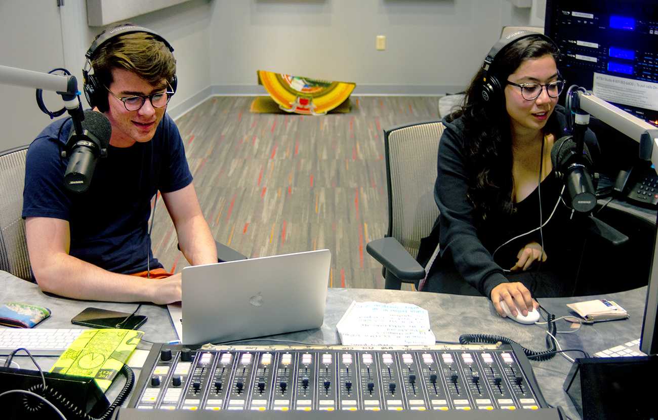Jack Kelleher (CGS '22) and Kelly Peña (CGS '22) are DJs on WTBU’s weeknight show “Left of the Dial.” It is one of the many shows that broadcasts on Boston University’s student-run radio station. CONOR KELLEY/ DAILY FREE PRESS STAFF