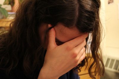 stressed person with her head in her hands