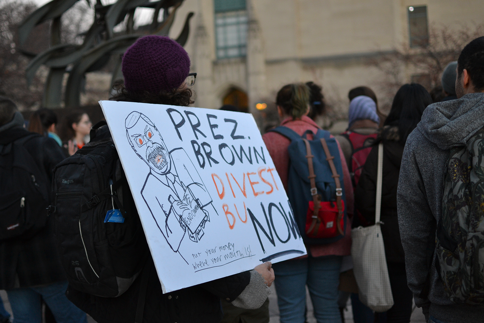 A student holds a sign denouncing Boston University President Robert Brown’s stance on divestment from fossil fuels during a Divest BU march Thursday afternoon. PHOTO BY CHLOE GRINBERG/ DAILY FREE PRESS STAFF 