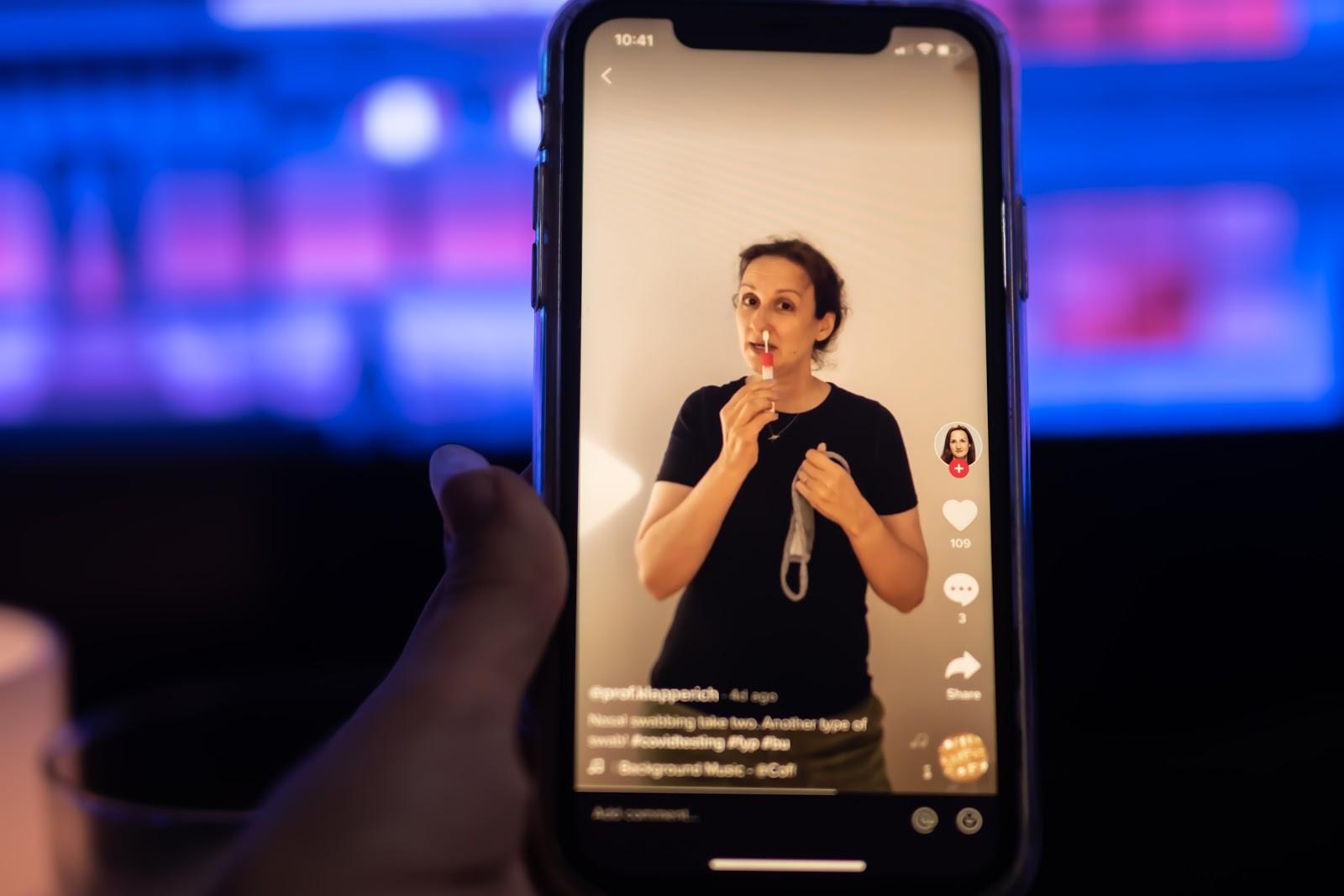 Director of the Boston University Precision Diagnostics Center Catherine Klapperich demonstrates how to self-administer a nasal swab test for COVID-19 in a video posted on TikTok. ILLUSTRATION BY LAURYN ALLEN/ DAILY FREE PRESS STAFF