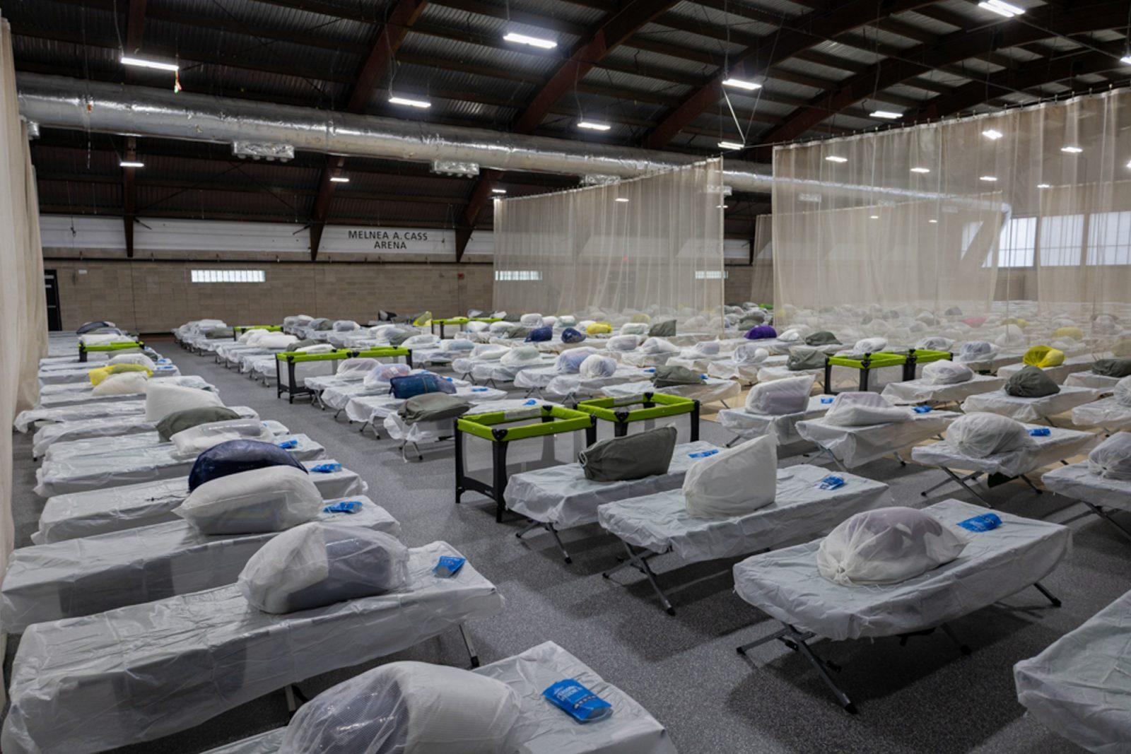 Cots set up in the Melnea Cass Recreational Complex in Roxbury for migrants who have been sleeping on the floor of Logan International Airport. This recreation center is the fourth overflow center to open in Massachusetts within the last two months due to the state’s shelter system being at full capacity. MATTHEW EADIE/DFP PHOTOGRAPHER