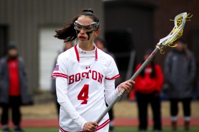 emily vervlied holds a lacrosse stick