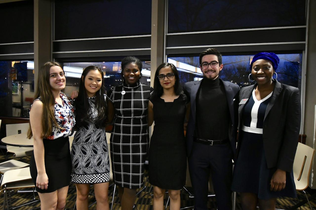 The members of the winning Student Government Executive Board slate, the four in the middle, pose with the Student Election Commission co-chairs, on the ends. RYAN GREGORY/ DFP STAFF
