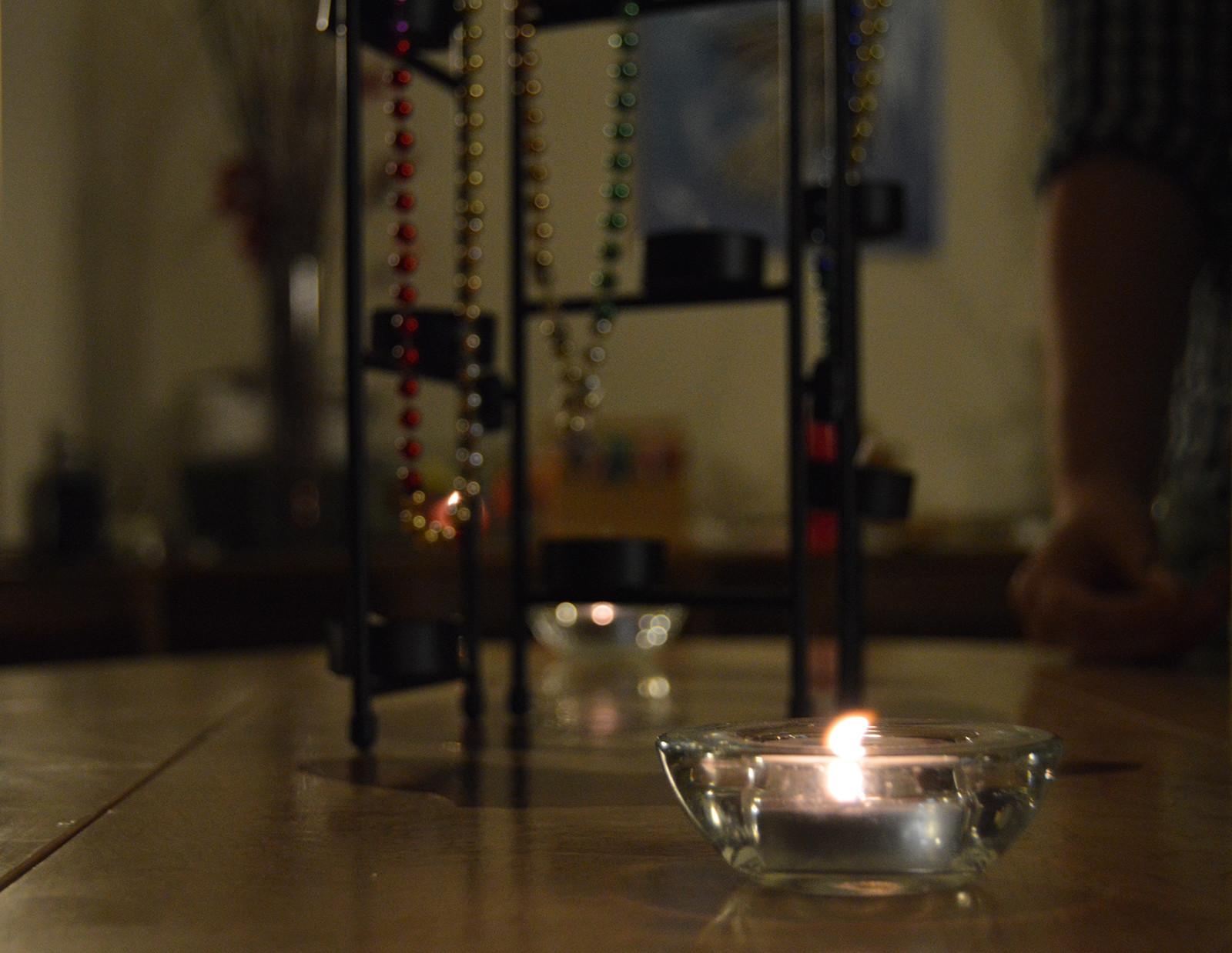 Candles were lit in honor of students' coming-out stories at the “Sacred Stories of Emergence” service at Muedler Chapel on Wednesday night. PHOTO BY ERIN BILLINGS/DAILY FREE PRESS STAFF