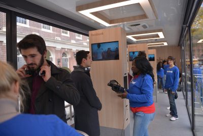 Facebook representatives describe the virtual reality experience to patrons in the booth. PHOTO BY SHANE FU/ DAILY FREE PRESS STAFF