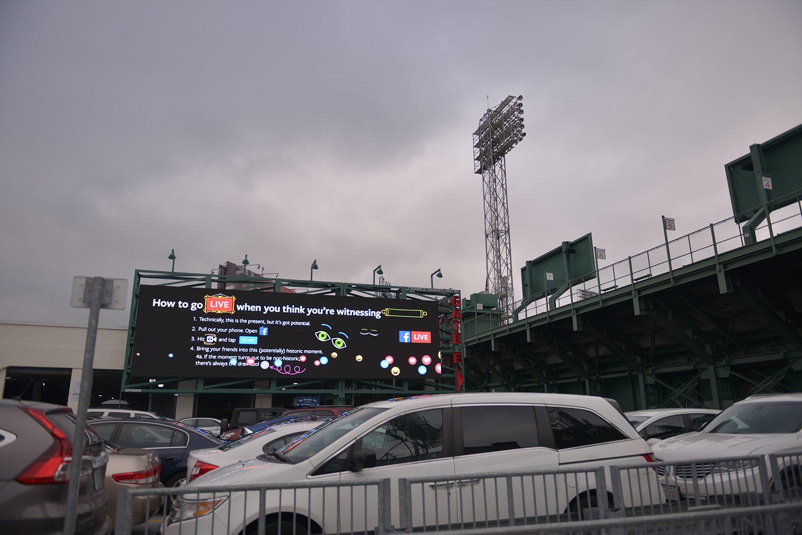 A new billboard outside of Fenway Park displays advertisements, train and bus times and other information for commuters. PHOTO BY SHANE FU/ DAILY FREE PRESS STAFF