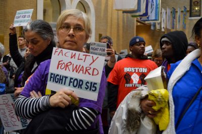 Protesters for the “Fight for $15” movement gather at the Massachusetts State House Tuesday afternoon. PHOTO BY CAROLYN KOMATSOULIS/ DAILY FREE PRESS STAFF