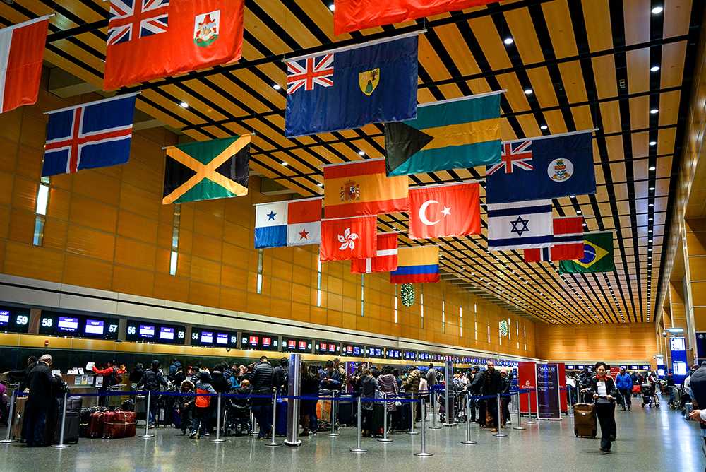 Flags of countries around the world hang overhead in the check-in area of Terminal E in Boston’s Logan International Airport. The inaugural William R. Keylor Travel Fund awarded five Boston University students with grants to conduct research in the United States and abroad. SERENA YU/ DAILY FREE PRESS STAFF