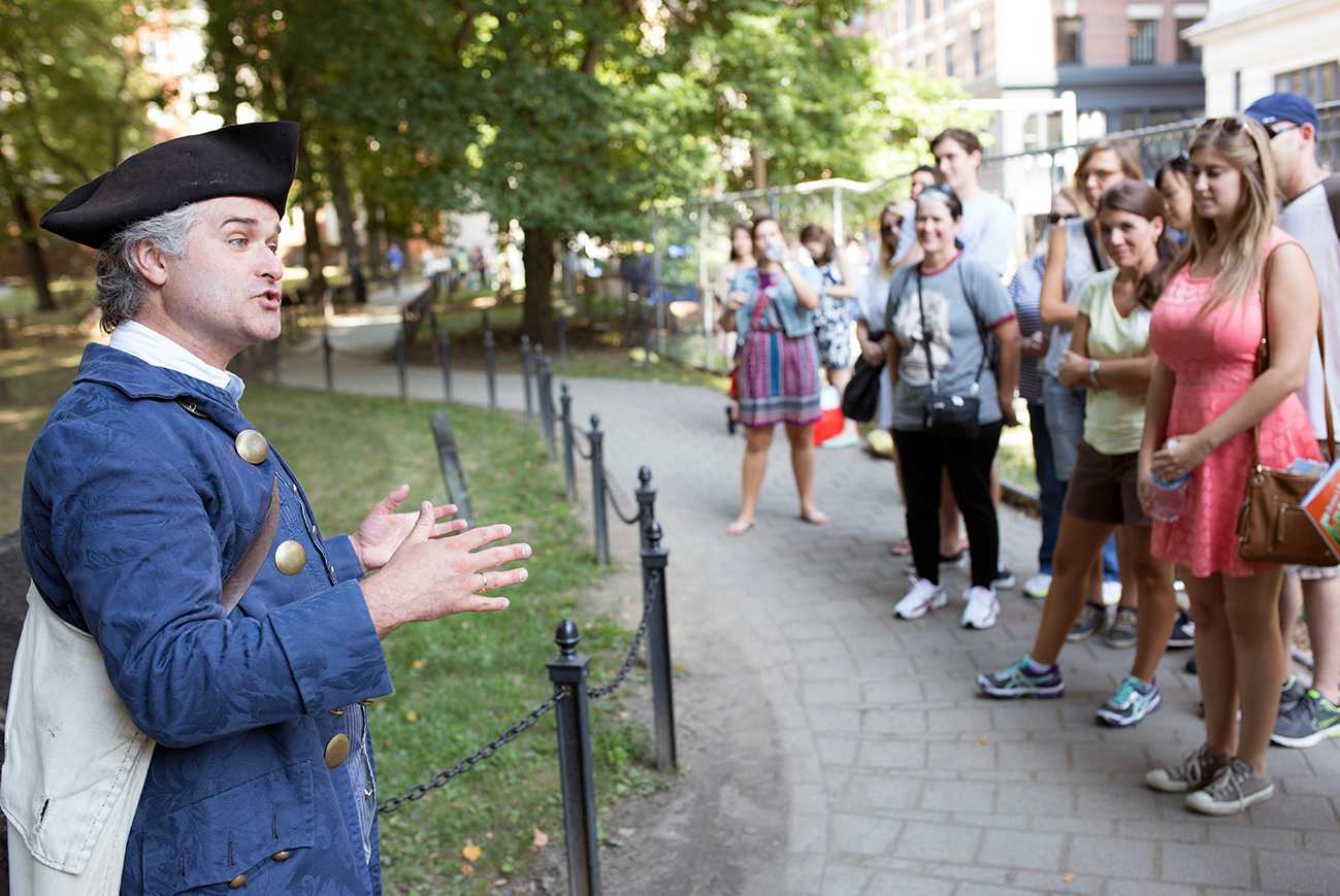 A tour guide stops to talk to tourists along the Freedom Trail. The trail leads from the Boston Common to the Bunker Hill Monument in Charlestown. COURTESY OF FREEDOM TRAIL FOUNDATION 