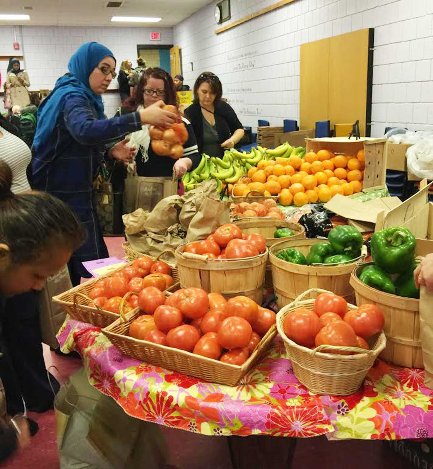 Students and faculty of Kennedy Longfellow Elementary School in Cambridge participate in the K-Lo market, a program started by the Food For Free organization which provides local families free nutritious foods. PHOTO COURTESY SASHA PURPURA