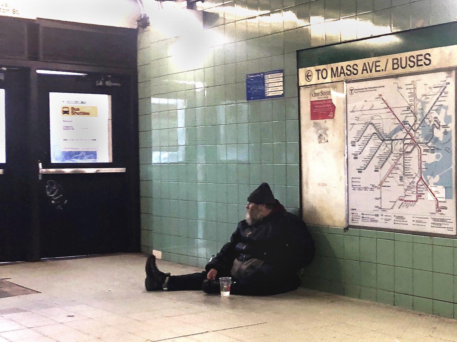 A man seeks shelter in the Hynes Convention Center MBTA station. The City of Boston is working to provide services and resources to aid people who are homeless this winter. HA NGUYEN/ DAILY FREE PRESS STAFF