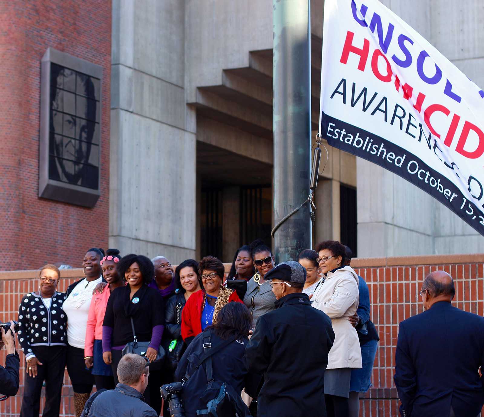 Women Survivors of Homicide activists and state leaders rose a flag to honor unsolved murders on Thursday in City Hall Plaza. PHOTO BY PAIGE TWOMBLY/DAILY FREE PRESS STAFF