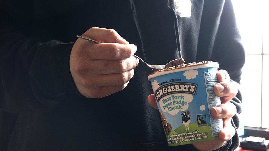 A student holds a pint of Ben &amp; Jerry’s ice cream. Ben &amp; Jerry’s launched a “Golden Pint Hunt” to celebrate Easter on Sunday. PHOTO BY MADHAV KOHLI/DAILY FREE PRESS STAFF
