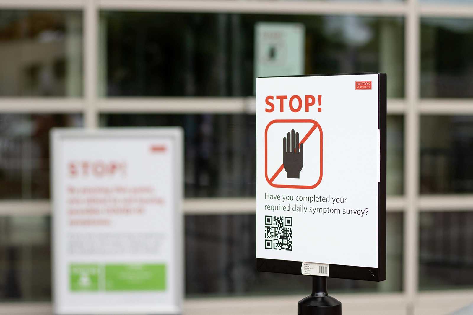 A sign outside Agganis Arena reminds students to complete their required daily symptom survey before entering the building to be tested. Students are finding loopholes in Boston University’s testing procedures, which allow them to arrive at their COVID-19 test earlier or later than scheduled. ROBERT BRANNING/ DAILY FREE PRESS STAFF
